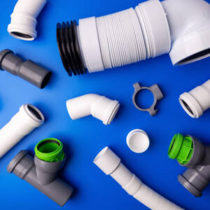 pvc drainage pipes and fittings on blue background. top view